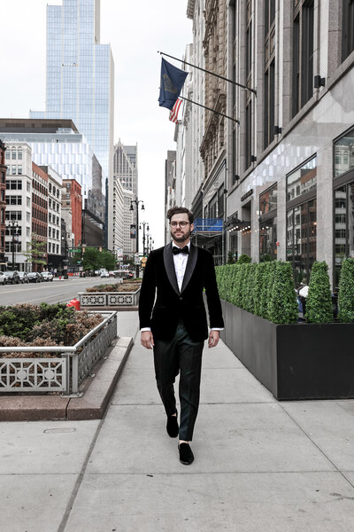 Groom walking downtown Detroit, MI on his wedding day.