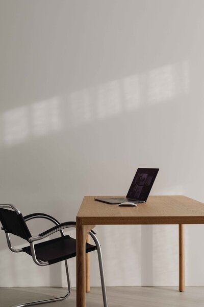 A design studio set up with a desk, office chair and laptop