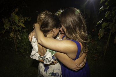 community of women supporting each other in a group hug