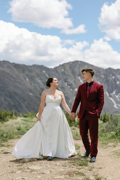 Bride and groom hold hands during Colorado elopement.