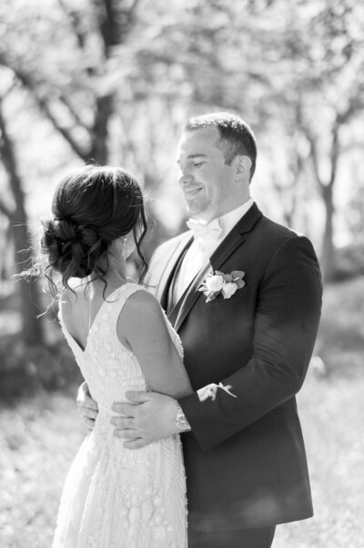 A black and white portrait of a bride and groom on their wedding day.