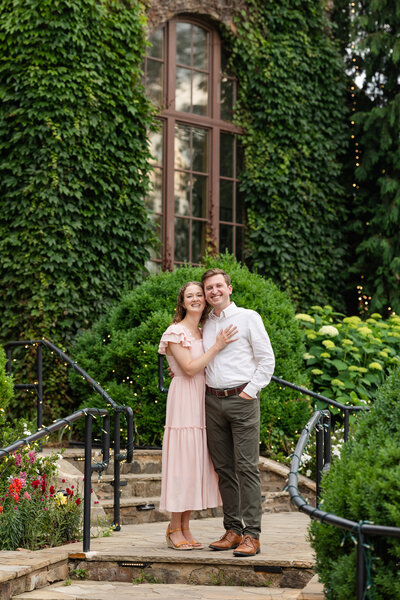 engaged couple sitting in a garden