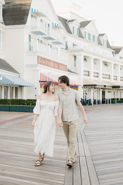 bride and groom holding hands walking on pier