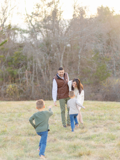 young boys run towards parents who wait with open arms