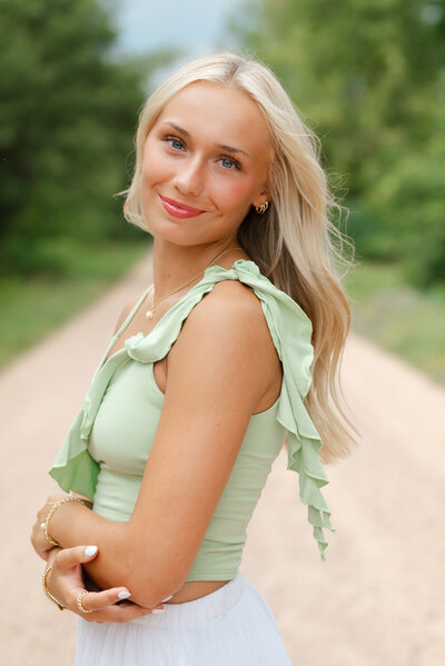 Outdoor headshot of a senior girl with natural lighting.