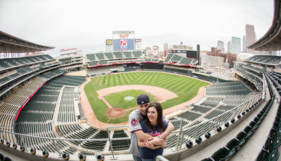 couple standing in baseball stadium seats