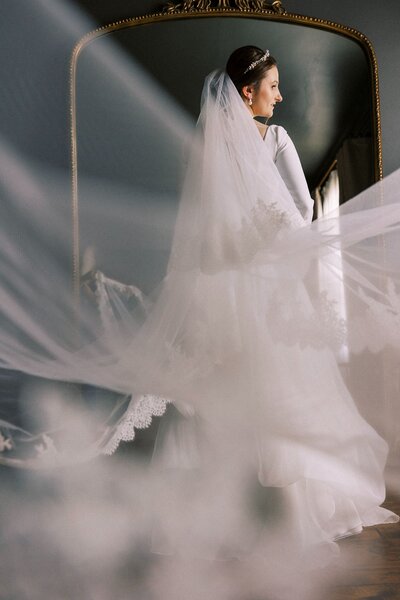 Bride getting ready with veil coming toward the camera