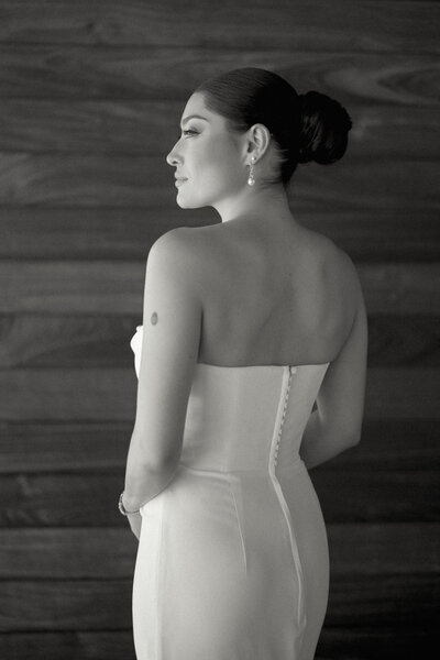 red headed bride in white Sareh Nouri bridal gown with lace bow standing on stairs