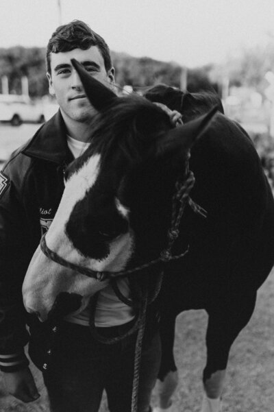 A baby in a boho green onesie laying on a crochet blanket.