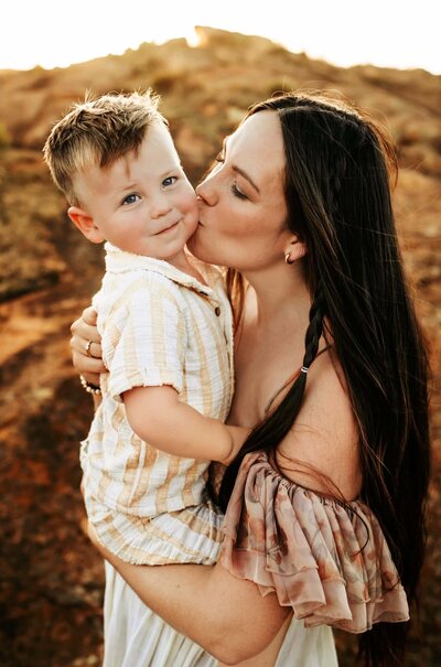 little girl running at park in boho styled dress and brown booties with ruffle socks while Paula Goforth takes her picture