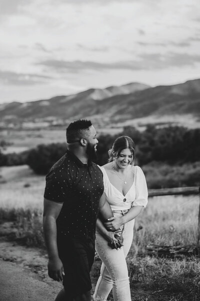 black-white-portrait-of-engaged-couple-walking