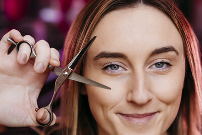 Carson City hairstylist posing with scissors at Studio 57.