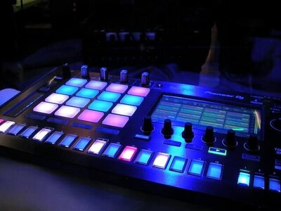 DJ sound board with pink , white and blue  lit up buttons