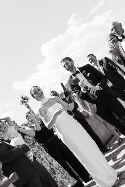 bride-and-groom-pop-champagne-after-wedding-ceremony