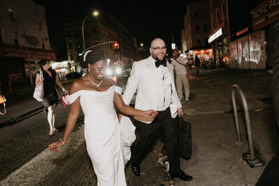 mixed newlyweds laughing and celebrating in New York City on wedding day