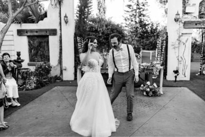 couple laughing together at their long beach wedding