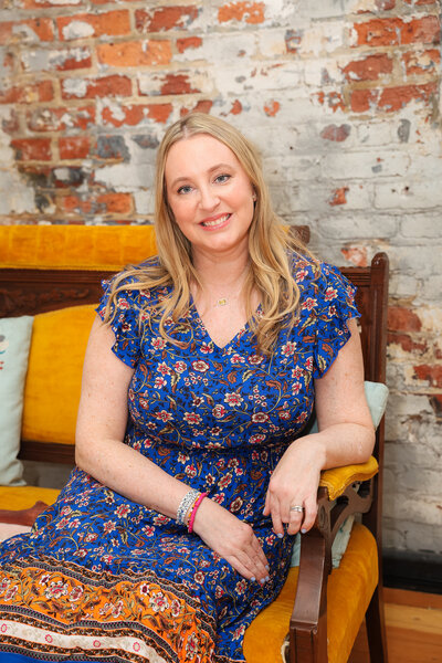 Shannon Russell sitting and smiling. Business Coach for women, author, and podcast host - Second Act Success.