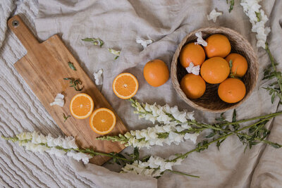 flatlay arrangement of oranges and flowers