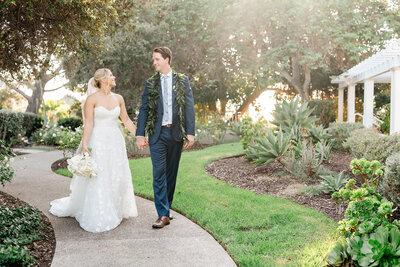 Bride and Groom walking holding hands at their wedding at Lauberge Del Mar