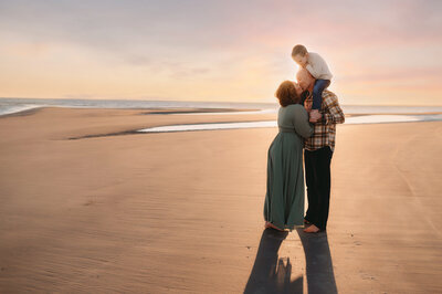 Family plays on the beach together during Family Photos on Kiawah Island, South Carolina.