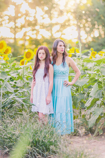 Mother and daughter in beautiful sunflower field in Brandon Mississippi