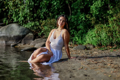 Photo of girl in white dress with legs in water
