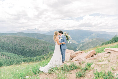 A bride and groom share a sweet moment at the Vail mountain wedding deck.