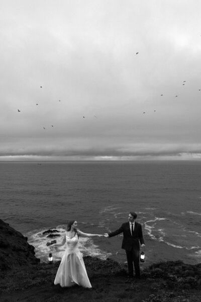 Bride holding up a bouquet of flowers during a beach elopement in Michigan.
