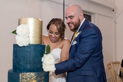 newly married couple cutting cake