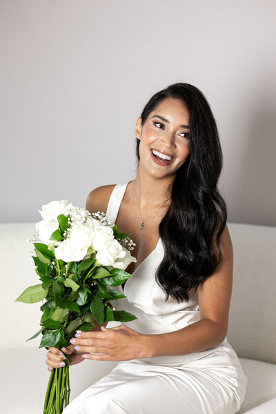 Brunette Bridal holding a bouquet in studio