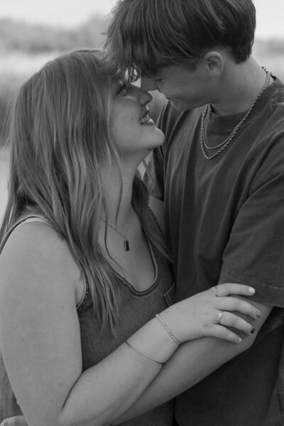 Black and white photo of a couple rubbing their noses together at Saguaro Lake