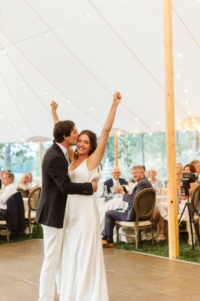 bride and groom holding hands while their bridal party is standing around them
