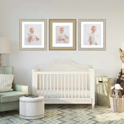 A nursery with wall art with pictures from the baby's photoshoot
