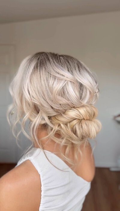 Bride with a low bun and soft, face-framing pieces — elegant and effortless wedding hairstyle by Klover Beauty for a Maryland celebration.