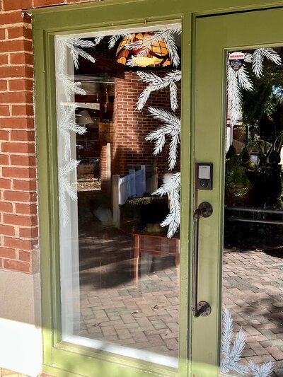 Hand drawn garland  on storefront windows of Cheshire, Connecticut business