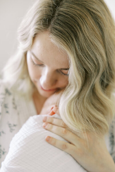 Baby sleeping peacefully in neutral swaddle during Fresno lifestyle newborn session
