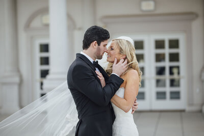 The Palace at Somerset Park Wedding | Couple Sharing Intimate Moment on Balcony in Winter Morning Light | Somerset, New Jersey