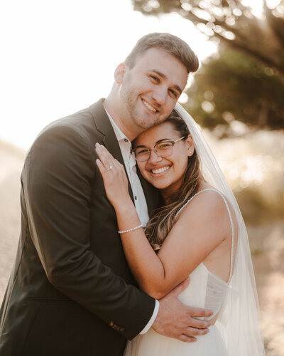 bride and groom embracing at Proposal Rock