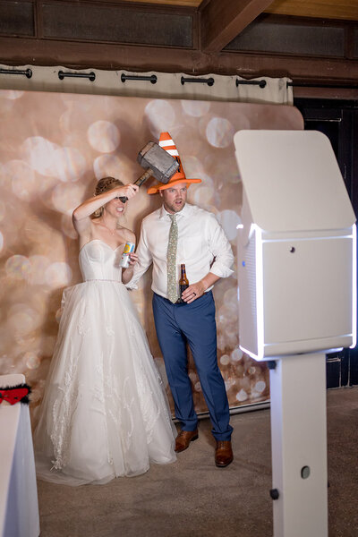 couple using photo booth at wedding