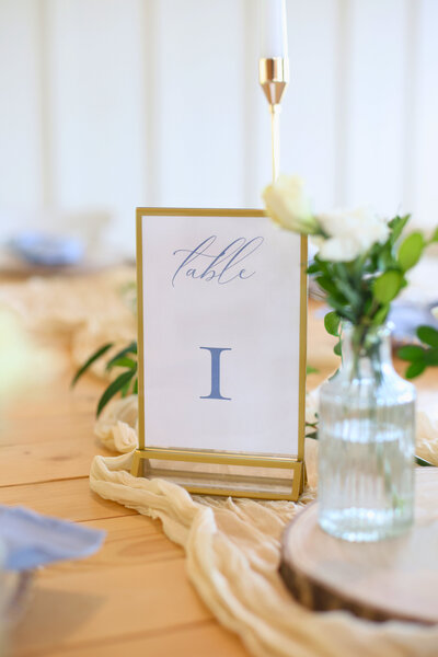 Detail photo of "Table 1" sign at reception table at Fireflies Farm