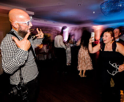 wedding photographer on dance floor taking photos