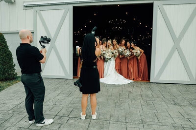 photographer taking a photo of a bride and bridesmaids