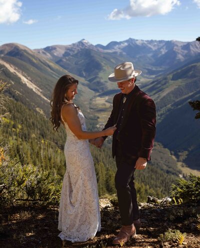 A first look during a wedding in Aspen Colorado at the top of a mountain at the Smiths Cabin