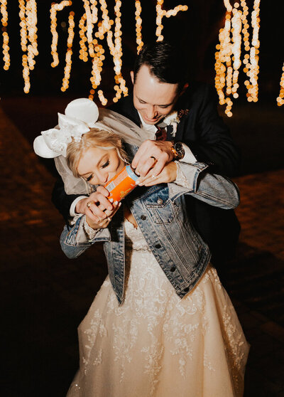 couple shotgunning a beer to celebrate getting married in dallas
