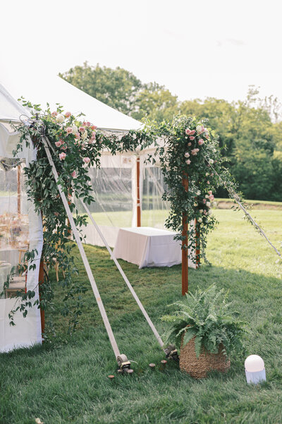 photo of white florals arranged on a table with a gold candle holder and tall white candle taken by Cleveland OH Wedding Photographer, Kristin Leanne