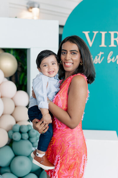 mom holding son at party by photographer minneapolis