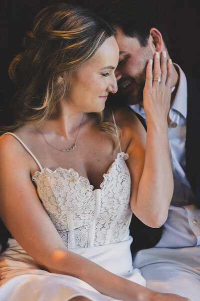 couple snuggle together during las vegas engagement photos at legacy club