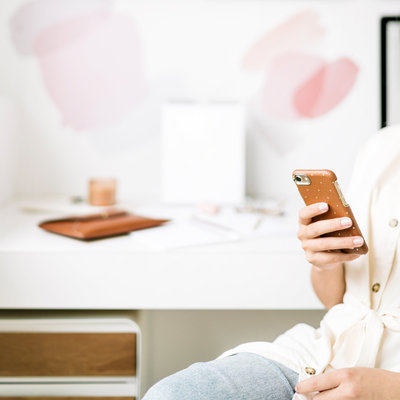 Woman in white office with cell phone