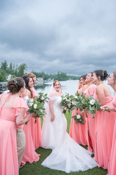 Bride showing off her dress to her bridesmaids