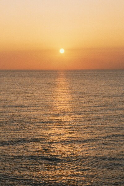 Orange sunset over ocean waves